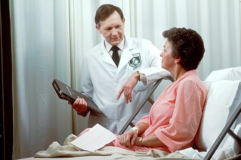 Doctor speaking with a patient in a hospital bed