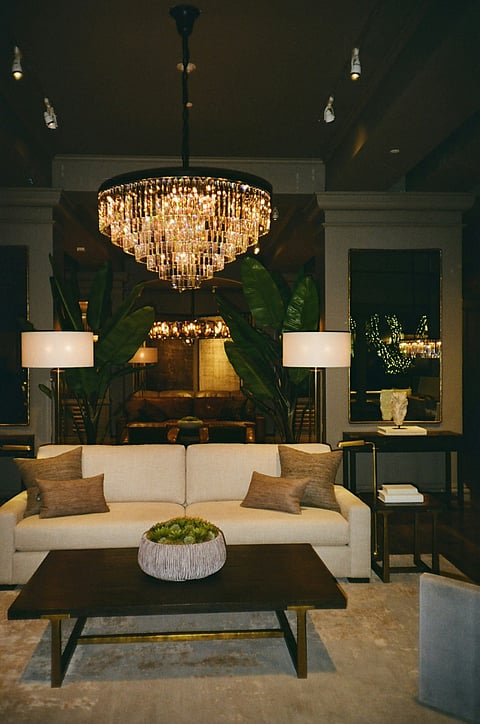 Elegant living room with chandelier, sofa, and modern décor.
