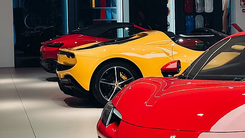 A row of sleek Ferrari cars displayed in a modern showroom