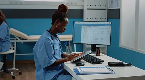 Medical staff member reviewing information on a tablet 