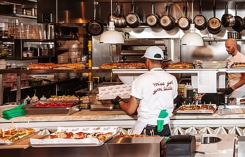 Chef in open kitchen at Bar Romy