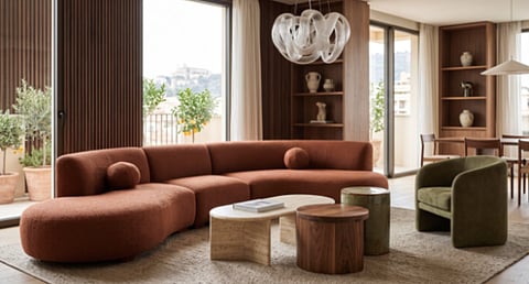 Modern living room with a curved rust-colored sofa