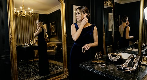 Woman in a blue dress with mirrors.