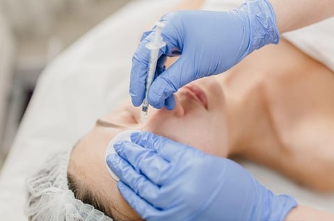 Person receiving a facial injection.