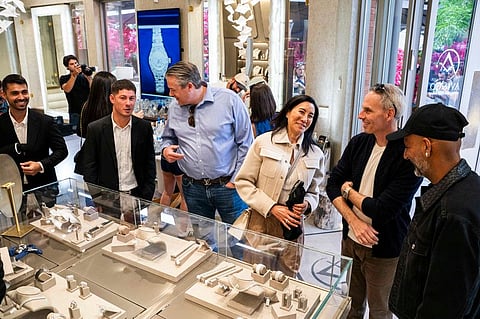 Guests examining watches in glass display cases at a Watch Week Aspen boutique event