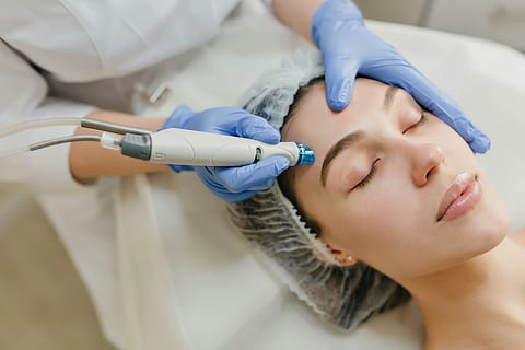 Woman receiving facial treatment.