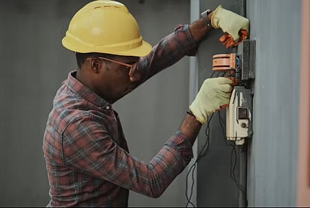 Man working on electrical panel.