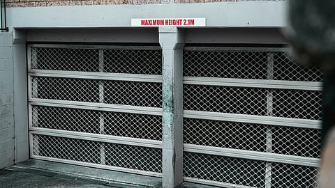 Garage doors with maximum height 2.1m sign.