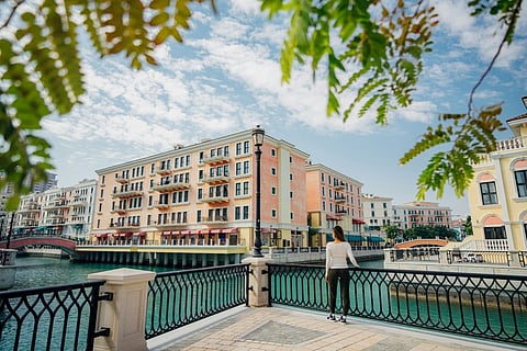 Woman overlooking a city canal.