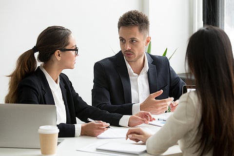Three people in a business meeting.