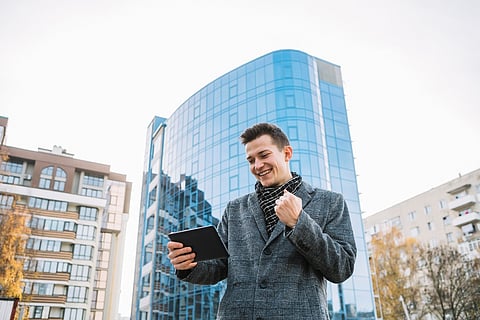 Man smiling at tablet