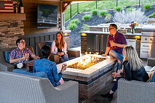 Friends raising glasses together outdoors on a late summer afternoon