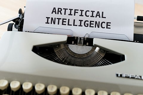 Typewriter with paper reading "ARTIFICIAL INTELLIGENCE"