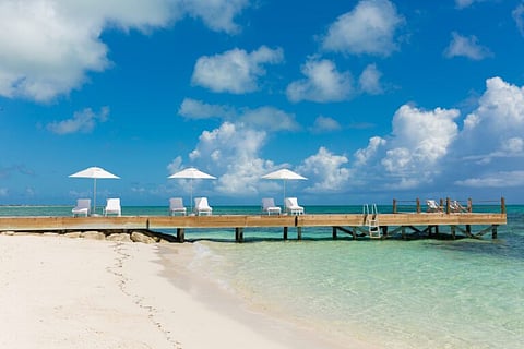 Cliffside loungers overlooking turquoise water at Rock House, Providenciales