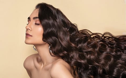 Woman with flowing wavy hair.