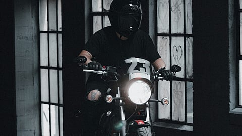 Person on a motorcycle indoors.