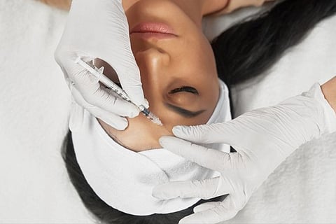 Woman receiving facial injection.