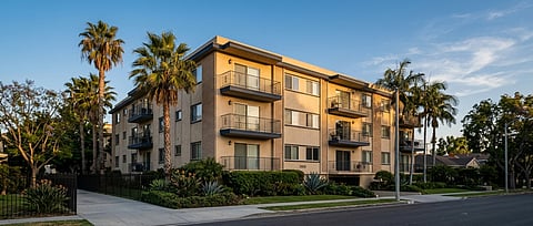 Apartment building with palm trees.