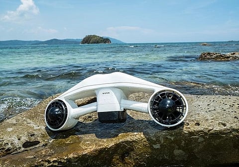 White underwater scooter on a rock.