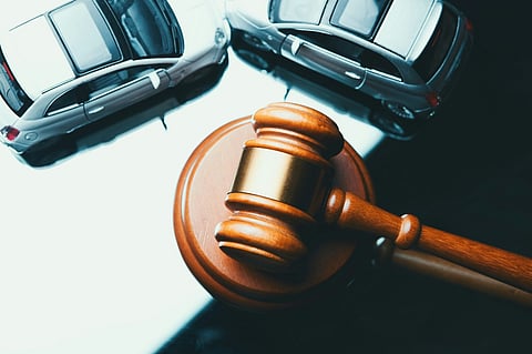 Gavel and crashed toy cars.