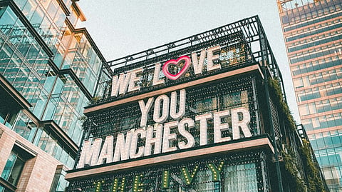 Building with We Love You Manchester sign.