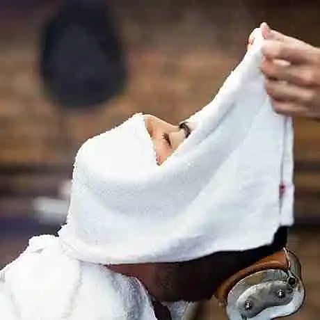 Hot towel on man's face.