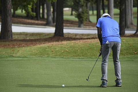 Golfer putting.