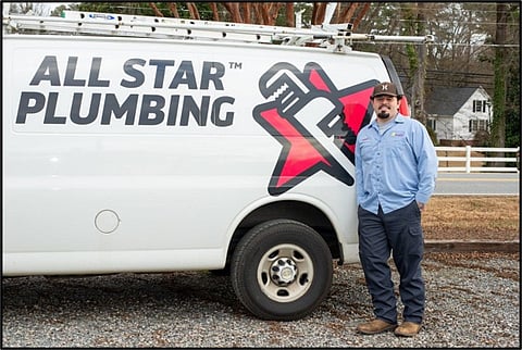 Plumber by company van.