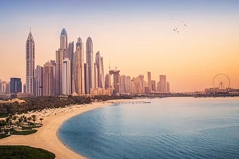 City skyline and beach at sunset.
