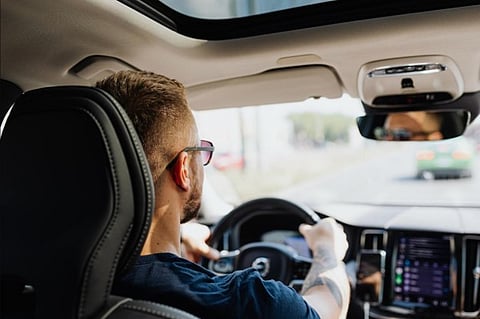 Man driving a car.