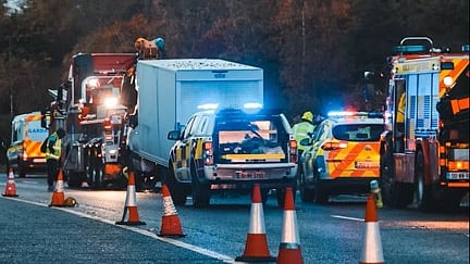 Emergency vehicles at a road incident scene.