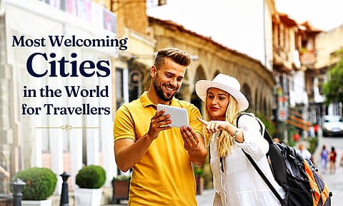 Couple looking at a device on a street with "Most Welcoming Cities" text.