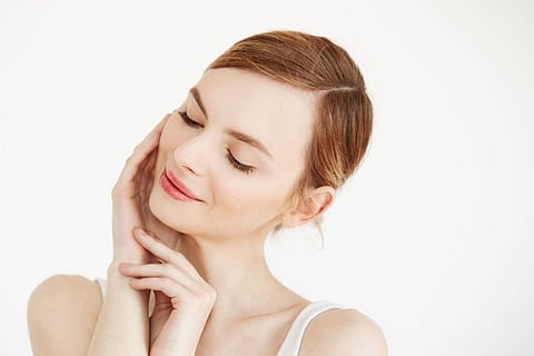 Woman touching her face.