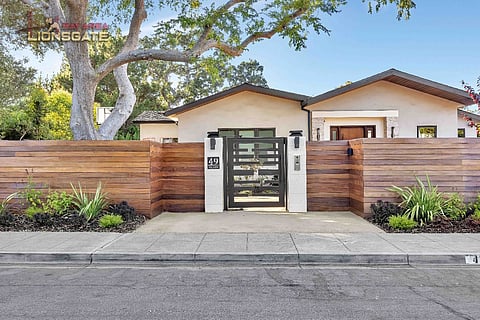 House with wood fence and gate.