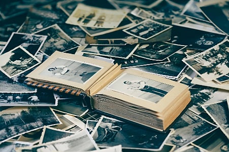 Scattered old photos and open album.