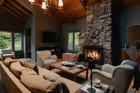 Living room with a stone fireplace.