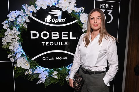 Maria Sharapova in front of the US Open and Dobel Tequila floral backdrop