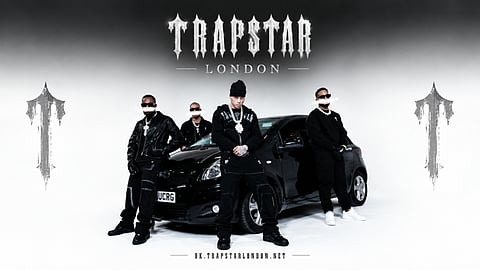 Trapstar London group posing with a car.