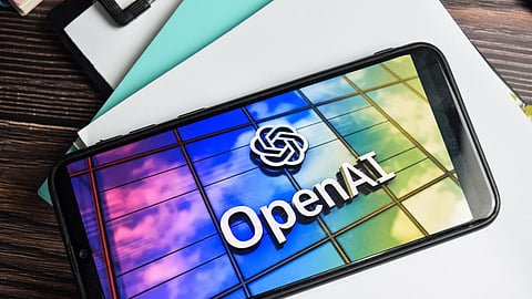 Phone on a table with the OpenAI logo.