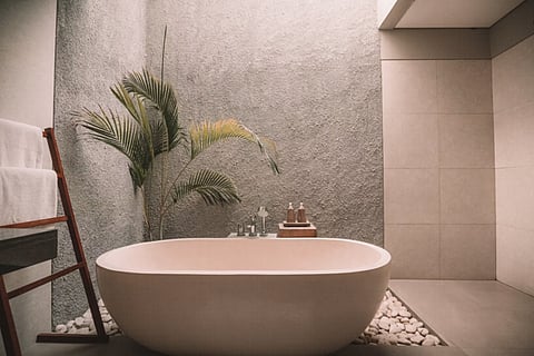 Freestanding bathtub in a minimalist bathroom.