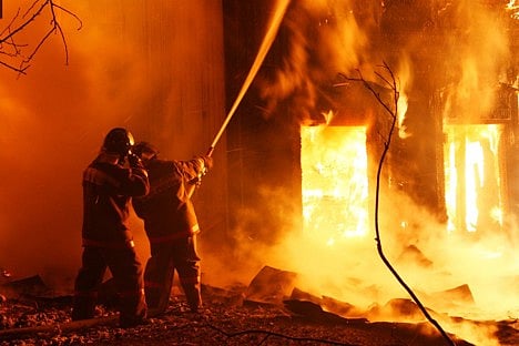 Firefighters battling a large fire.
