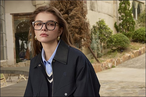 Woman wearing glasses outdoors.