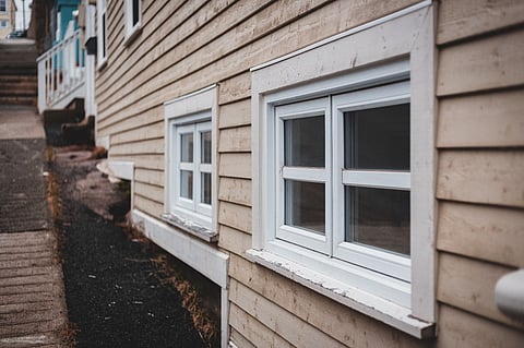 White windows on a wooden house.