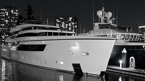 Luxury yachts docked at night.