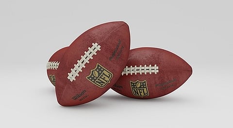 Three NFL footballs.