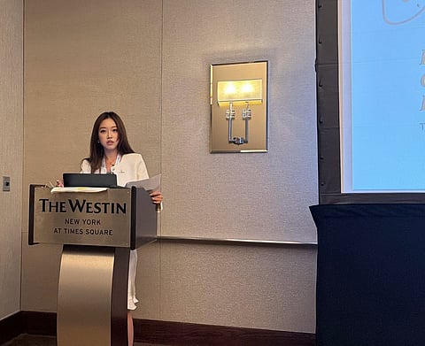 Woman speaking at a podium.