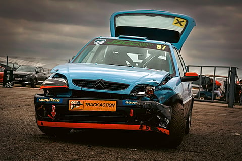 Damaged blue race car.