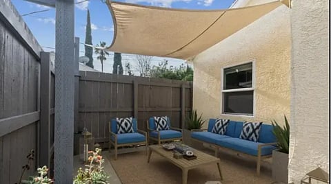 Patio with shade sail and seating.