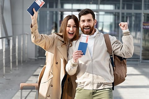Excited couple holding passports