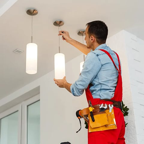 Man fixing a ceiling light